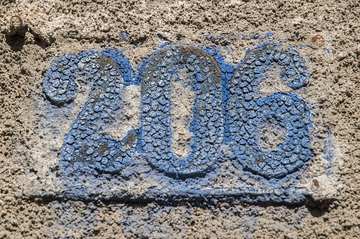 Ceramic Number 90 Street Address; Black and white Mexican tiles on adobe wall. Shot in Santa Fe, NM.