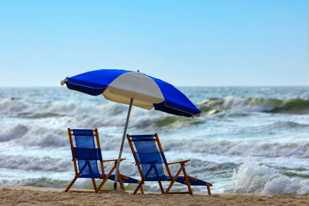 istock Blue and white lounge chairs on the beach 1475854999
