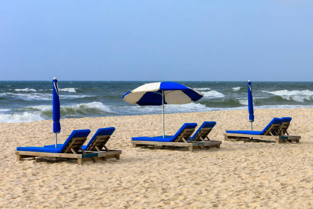 istock Blue and white lounge chairs on the beach 1475855033