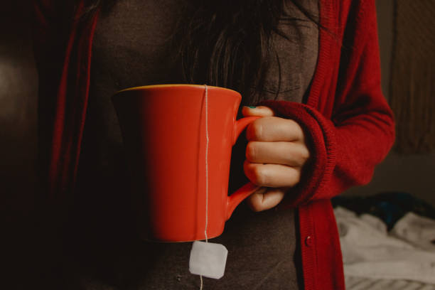 istock woman holding a mug of tea 1475855831