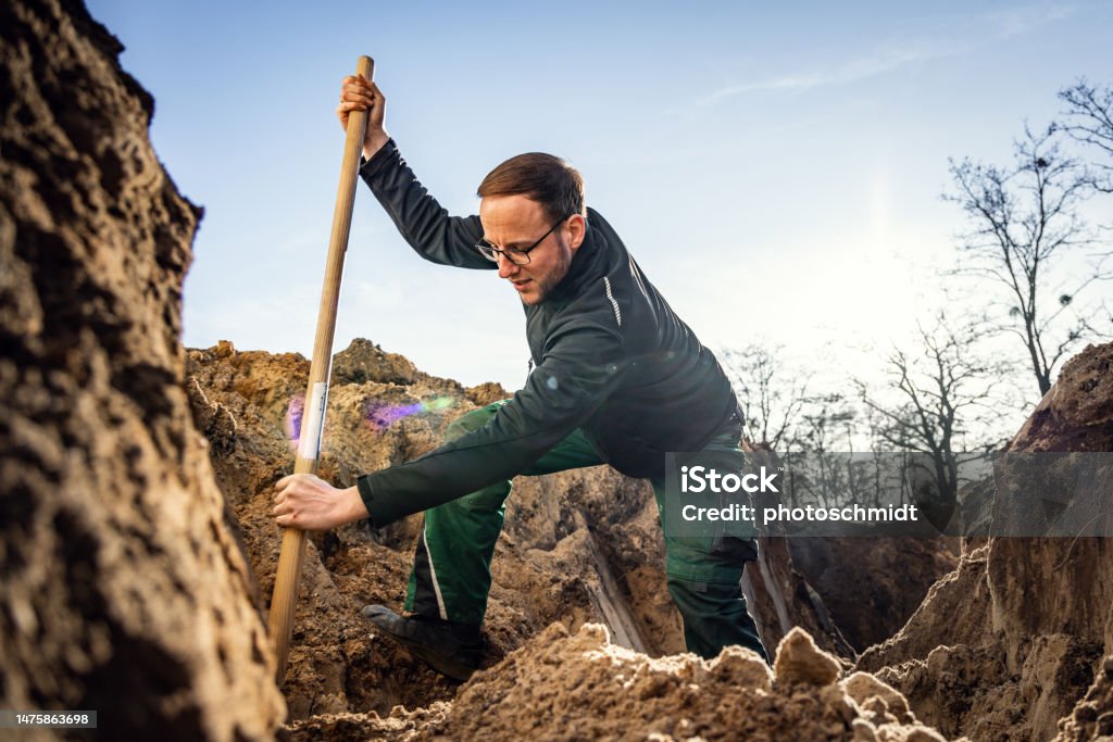 Working Digging Worker Inside A Large Hole Digging With A Shovel Stock Photo - Download ...