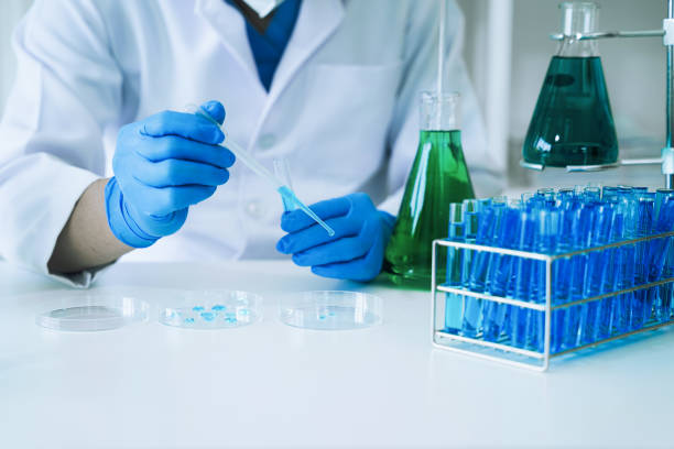 istock Science and medicine, scientist analyzing and dropping a sample into a glassware, experiments containing chemical liquid in laboratory on glassware, innovative and technology. 1475864335