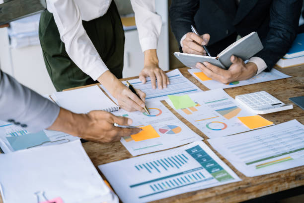 istock Businessmen team or financial data analysts working with tablets and laptop computers and data graphs together. Plan to analyzing projects. 1475864385