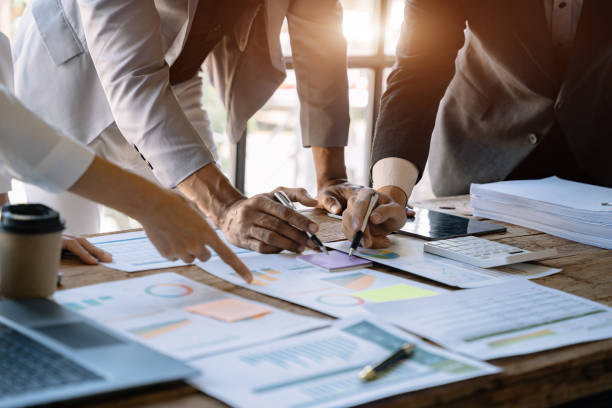 istock Businessmen team or financial data analysts working with tablets and laptop computers and data graphs together. Plan to analyzing projects. 1475864400