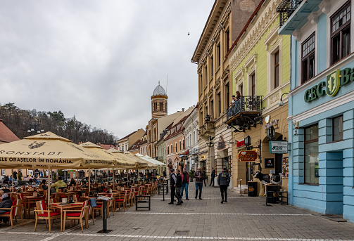Brasov, Romania. March 15, 2023: Street cafes in the Old town Brasov in Romania with seating