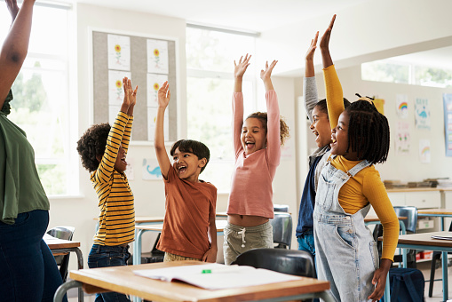 Kids, happy stretching and classroom question for health, wellness and children growth in a school. Students, exercise and happiness of young group in a education study hall with student motivation