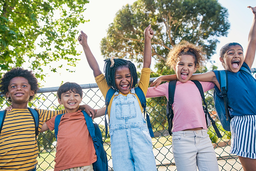 Children excited, playground portrait and hug of kids in nature ready for fun and bonding in summer. School backpack, morning and diversity of young friends together with a smile feeling happy