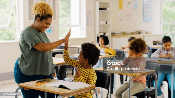 Education High Five And Teacher With Children In Classroom For Learning Support And Motivation Study Assessment And Development With Student And Woman In School For Celebration Exam And Result Stock Photo - Download Image Now