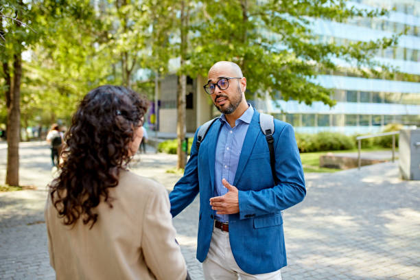 istock Corporate associates debating a point in office park 1475871618