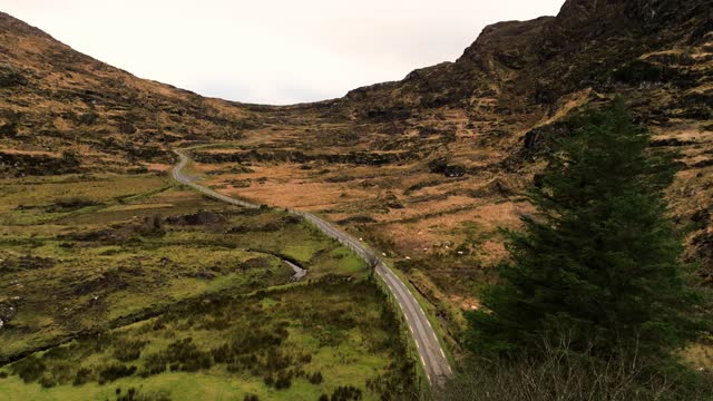 Aerial view of Gap of Dunloe, County Kerry in Ireland,Aerial view of scenic mountain pass, aerial nature and road view, aerial view of winding road, nature relax video, car driving the winding road between the mountain