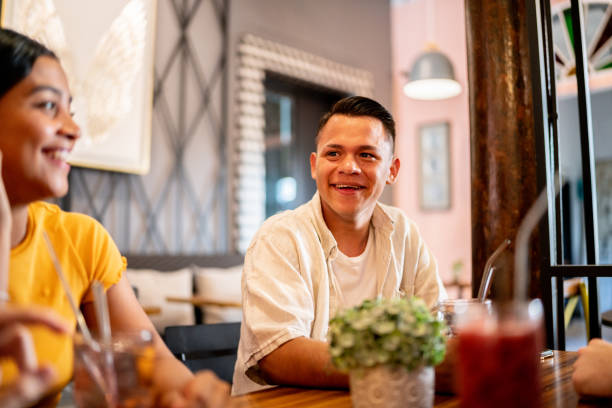 istock Young man talking with his friends at a bar 1475876740