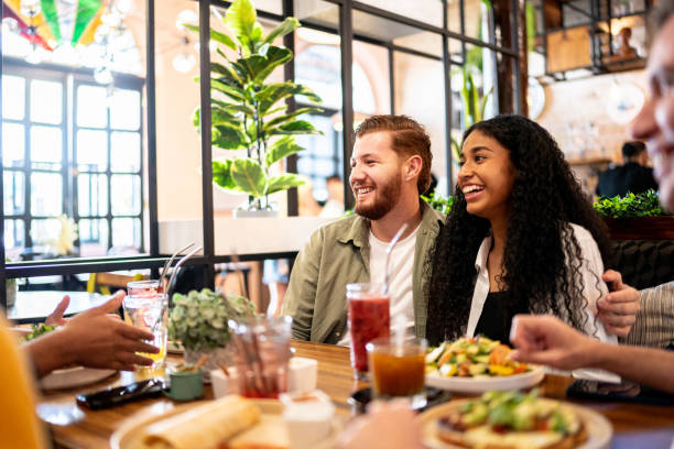 istock Couple talking with their friends on a restaurant 1475879059