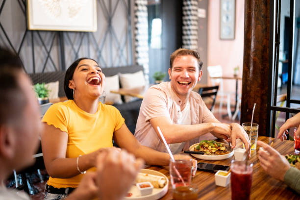 istock Happy friends talking and eating on a restaurant 1475879207