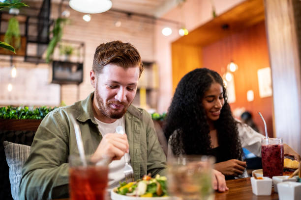 istock Young man eating with his friend on a restaurant 1475879327