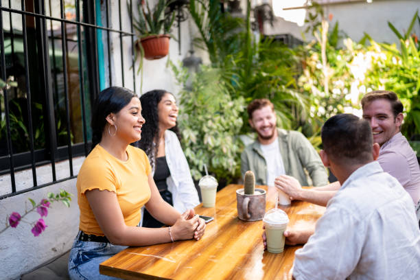 istock Happy friends talking sitting at a table 1475879982