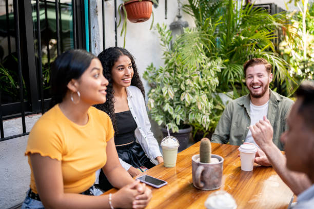 istock Happy friends talking sitting at a table 1475880018