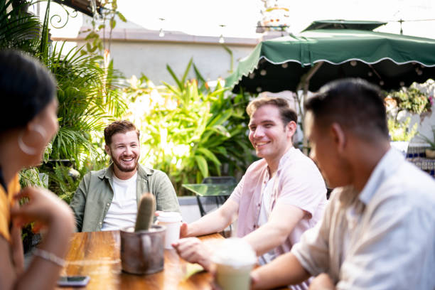 istock Young friends men talking sitting at a table 1475880304