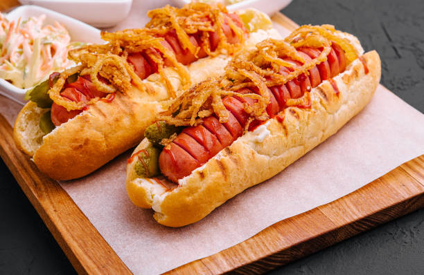 Delicious Gourmet Grilled Hot Dogs With Mustard, Pickles, Onion stock photo