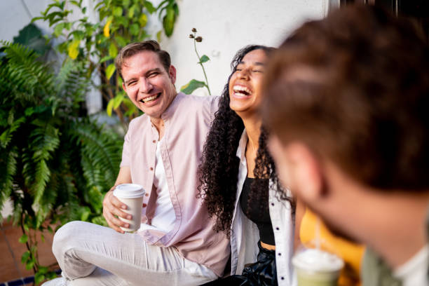 istock Happy young man talking with his friends at home 1475881637