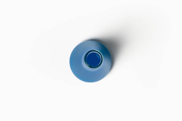 istock Laboratory flask with blue, blue liquid. On a white, light background. View from above. 1475881763