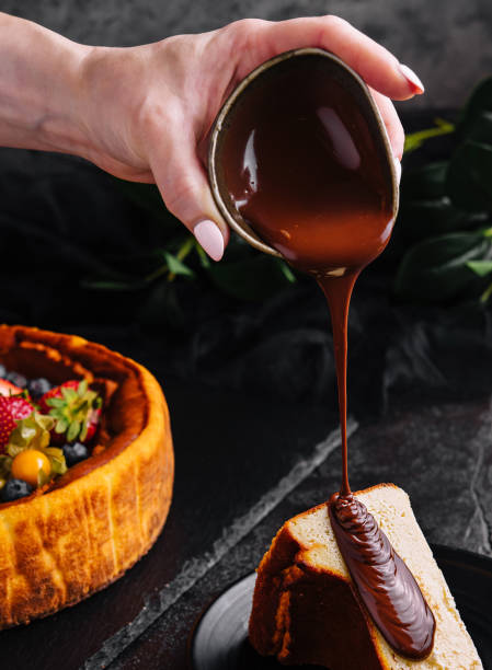 istock Pouring chocolate on delicious cheesecake and berries 1475881774