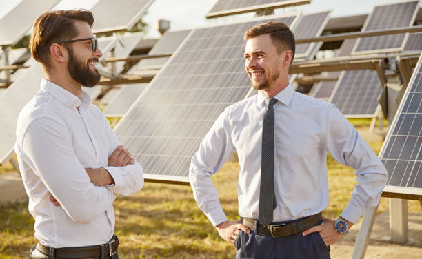 istock Smiling business partners discussing work in solar power station 1475881806
