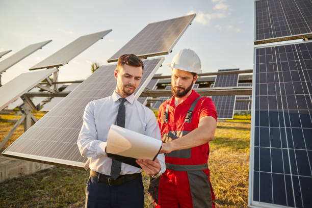 istock Entrepreneur reading papers with contractor in solar power plant 1475881846