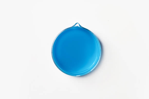 istock Crystallization cup for laboratory with blue, blue liquid. On a white, light background. View from above. 1475882310