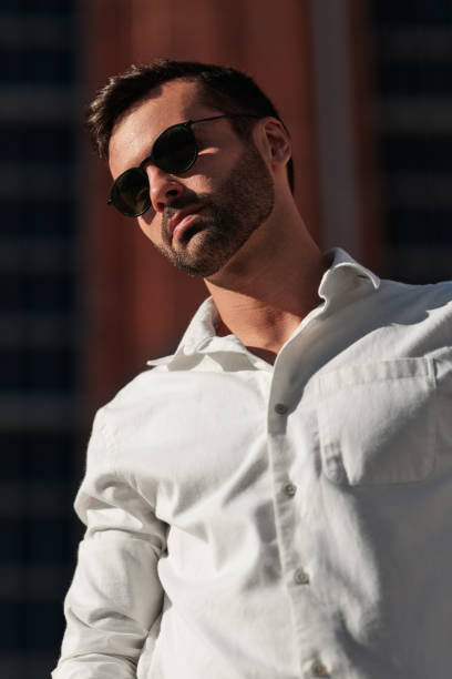 istock Confident stylish ethnic guy standing on street in summer 1475885158