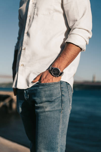 istock Crop faceless man with hand in pocket standing at seaside 1475885258
