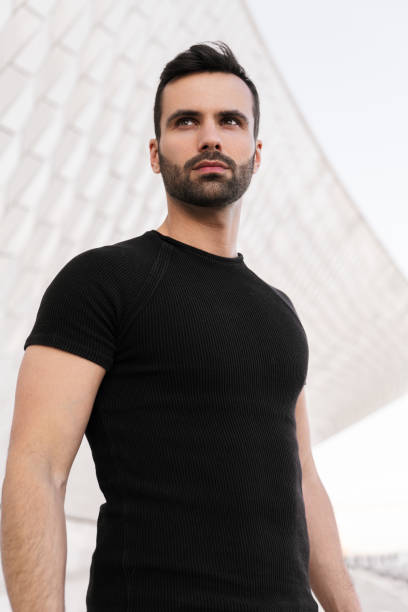 istock Serious bearded ethnic guy looking away against contemporary building 1475885398