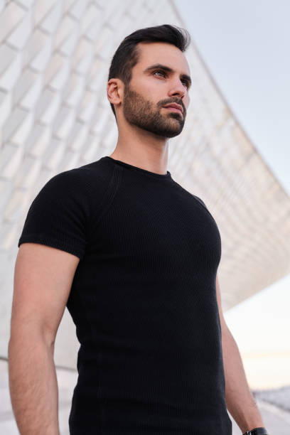 istock Young ethnic man against modern building 1475885433