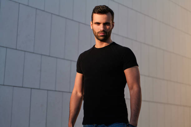 istock Serious muscular ethnic guy looking at camera with confidence on street 1475885499