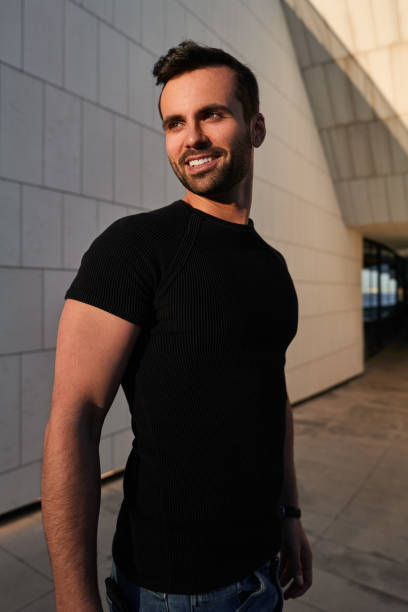 istock Positive young Arab guy smiling on street at sundown 1475885561