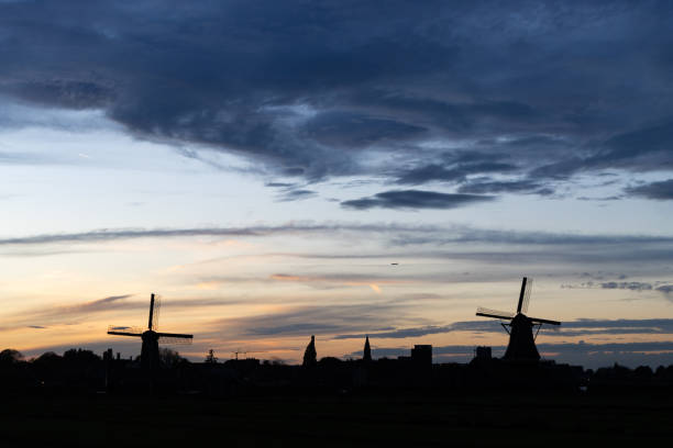 istock Zaanse Schans Windmill Landscape Silhouette during an Evening Sunset in the Netherlands 1475885897