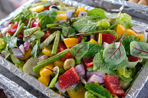 Close-up shot of healthy green mix salad. There's so many variation vegetables inside the aluminium tray foil.