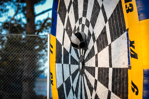 Huge inflatable target with the ball hitting the target at open team building games outdoor.