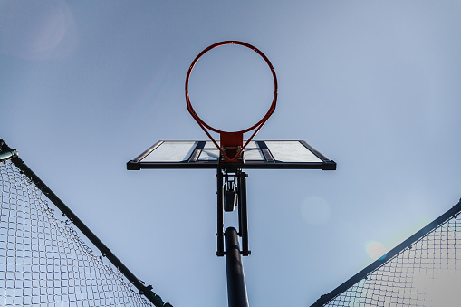 Streetball basket outdoor. Blue sky as background and copy space. bottom view.