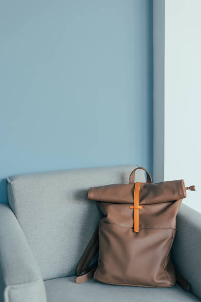 istock Lovely mocha color backpack on an armchair. 1475894963