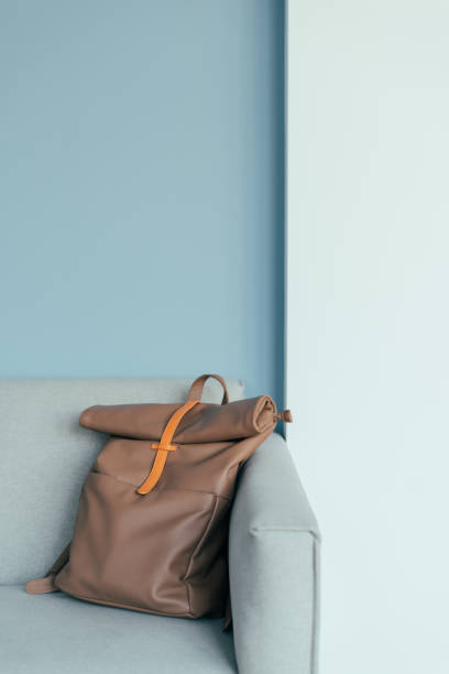 istock Lovely mocha color backpack on an armchair. 1475894964