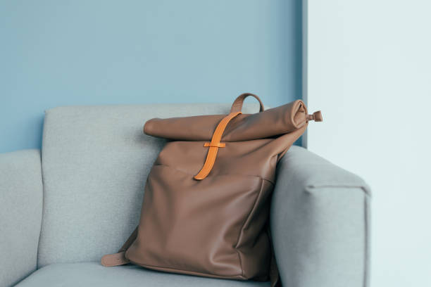 istock Lovely mocha color backpack on an armchair. 1475894973