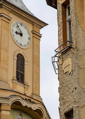 Ancient wall clock on a white background. The clock is eight in the morning or evening.