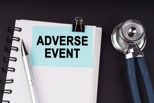 istock On a black surface, a stethoscope, a notebook, a pen and a blue sticker with the inscription - ADVERSE EVENT 1475906214