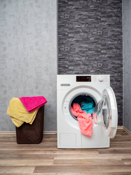 istock Laundry room interior with washing machine against the wall. 1475906488