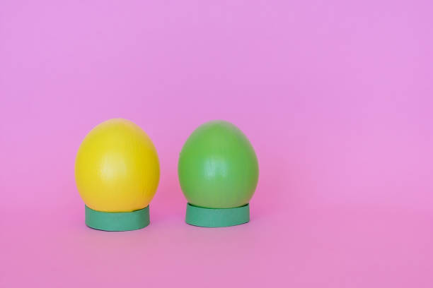 istock Easter eggs in a vertical position of yellow and green. 1475909873