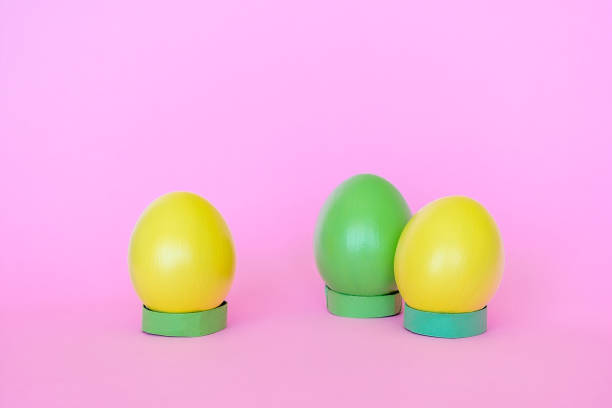 istock Easter eggs in a vertical position of yellow and green. 1475910663