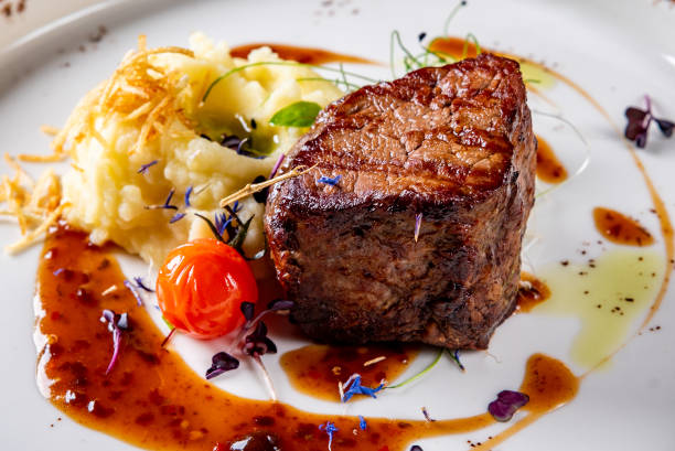 istock Grilled beef steak filet mignon with potato and sauce in plate 1475911014