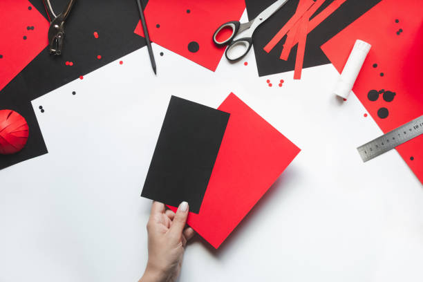 istock How to make paper red and black ladybug toy with children at home. Step by step instructions. Hands making DIY summer project. Top view. Step 1. Take sheets of colored paper 1475911502
