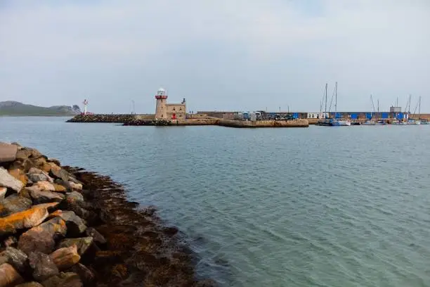 Howth Lighthouse. Harbor and marina in cloudy day in Howth, Dublin, Ireland.