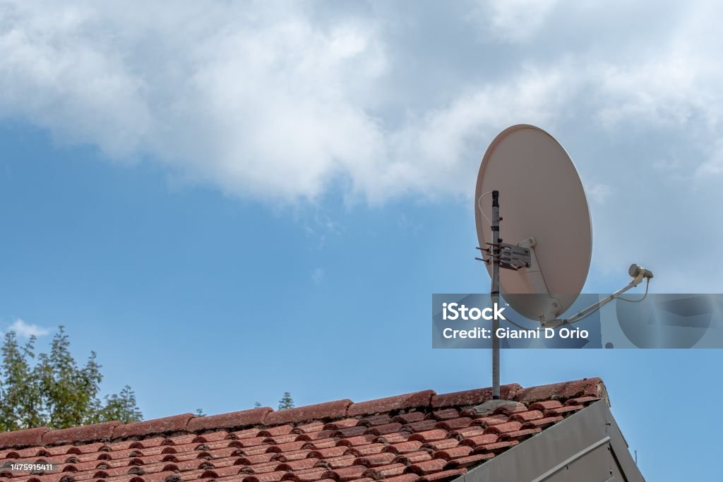 Satellite dish on the roof Antenna - Aerial Stock Photo